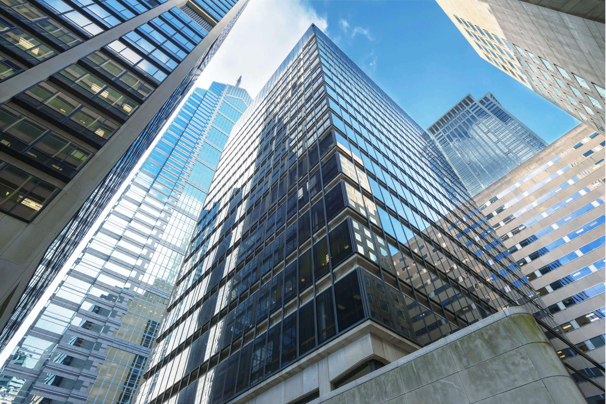 Commercial skyscraper building, low angle shot against blue sky