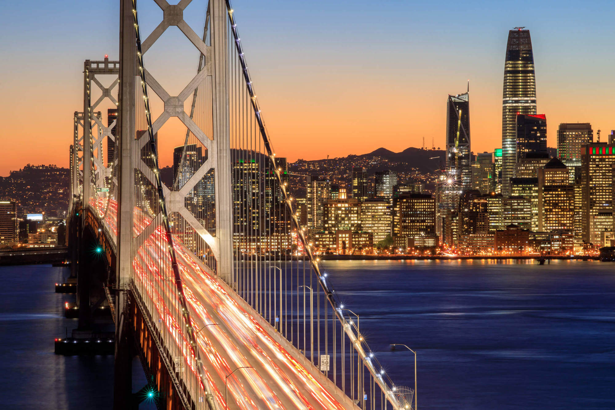 San Francisco, California, Bay Bridge and skyline at dusk